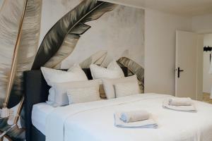a bedroom with a large white bed with white pillows at Garden Spa Suite - Private Sauna & Whirlpool in Betzdorf