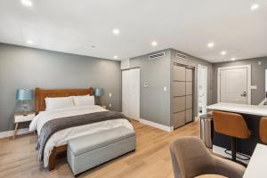 a bedroom with a large bed and a chair at 24 Stay - Philadelphia Rittenhouse in Philadelphia