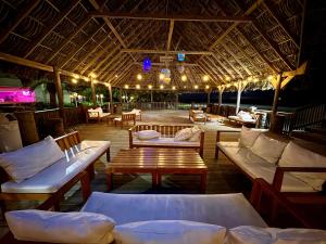 a patio with couches and a table and chairs at Hotel Palma Real in Sambo Creek
