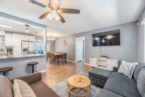 a living room with a couch and a table at Ocean Blue Heated Pool Home in Largo