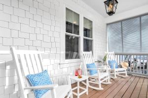a porch with two white chairs and a table at SeaPines on 30A in Santa Rosa Beach +66 photos