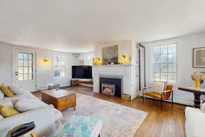 a living room with a fireplace and a couch at The Hilltop in Waterbury