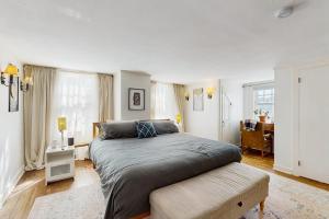 a bedroom with a large bed and a desk at The Hilltop in Waterbury