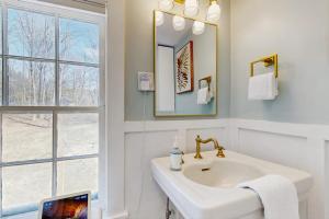 a white bathroom with a sink and a window at The Hilltop in Waterbury +32 photos