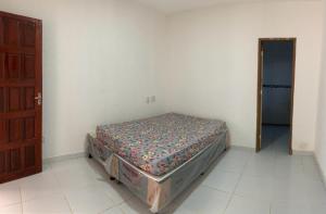 a bedroom with a bed in a room with a door at Casa em jacuma vip in Conde