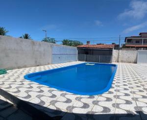 a large blue swimming pool on a patio at Casa em jacuma vip in Conde +6 photos