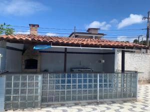 a house with a glass fence in front of it at Casa em jacuma vip in Conde