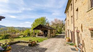 a stone building with a small kiosk next to it at Ca' d'Alfieri in Bardi
