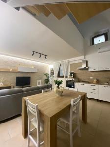 a kitchen and living room with a wooden table and chairs at Nardò apartment in Nardò