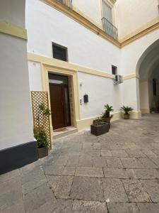a courtyard with potted plants in front of a building at Nardò apartment in Nardò