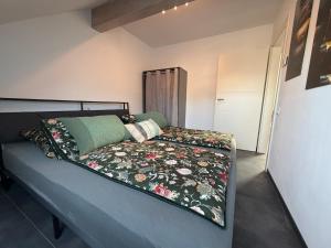 a bed with a blanket on top of it in a room at Mira Suites 3 in Schwalbach