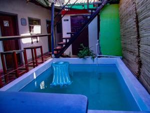 a swimming pool in a building with a staircase at Deakachimba Hostel in Granada
