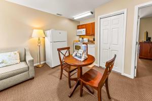 a living room with a table and chairs and a couch at Cozy 1st floor condo with golf course view in New Bern
