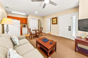 a living room with a couch and a table at Cozy 1st floor condo with golf course view in New Bern