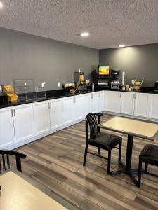 a waiting room with a table and chairs and a counter at Days Inn by Wyndham Sturgis SOUTHDAKOTA in Sturgis