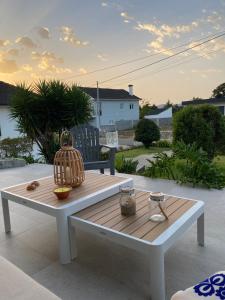 a white table and bench on a patio at A casa das hortênsias- caminho de Santiago in São Pedro da Torre +4 photos