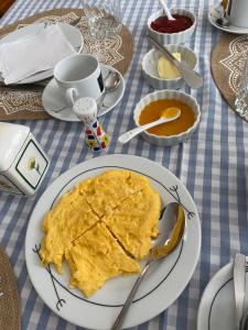 a plate of omelet on a table with a plate of pancakes at A casa das hortênsias- caminho de Santiago in São Pedro da Torre