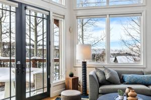 a living room with a couch and windows at Pine Meadows 135 ~ Pine Meadows 135 in Telluride