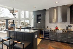 a kitchen with gray cabinets and a large island at Pine Meadows 135 ~ Pine Meadows 135 in Telluride