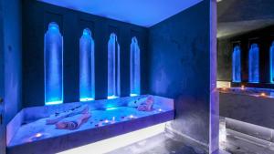 a blue room with a tub with shoes in it at Dreamcation Villa in Marrakesh