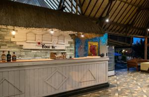 a bar in a resort with a refrigerator and a counter at The Dafish Ceningan in Nusa Lembongan