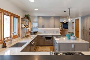 a large kitchen with a sink and a stove at Benchmark Dr 101 in Telluride