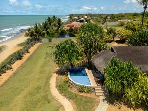 an aerial view of a resort with a swimming pool and the ocean at Pousada Spa dos Amores in São Miguel do Gostoso