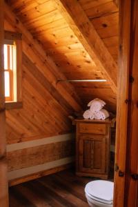 a bathroom with a toilet in a wooden attic at Ivy Retreat in Sevierville