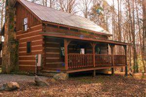 a cabin in the woods with a large deck at Mountain Hideaway in Sevierville