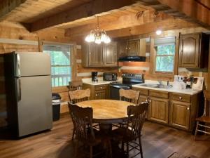 a kitchen with a table and a refrigerator at Mountain Hideaway in Sevierville