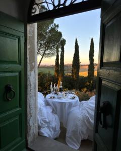 a table with a white table cloth in a doorway at Villa Cozzano in Pozzuolo
