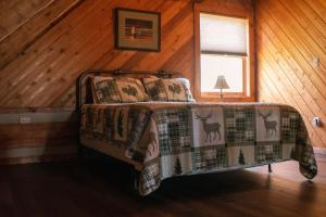 a bedroom with a bed in a wooden room at Ivy Retreat in Sevierville