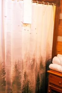 a shower curtain with a picture of trees and birds at Mountain Hideaway in Sevierville +12 photos