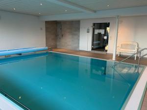 a large swimming pool in a building at Ferienresidenz Seegarten Andrea - Seezugang und Schwimmbad in Bodman-Ludwigshafen