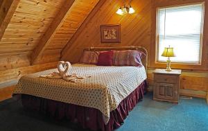 a bedroom with a bed with a stuffed animal on it at Trails End- Your Romantic Getaway Awaits! in Sevierville