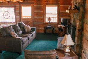 a living room with a couch and a table at Trails End- Your Romantic Getaway Awaits! in Sevierville