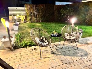 two chairs and a table on a patio at Astrea Apartament in Tropea