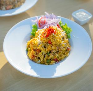 a plate of food with rice and vegetables on a table at Amotape Hotel in Zorritos