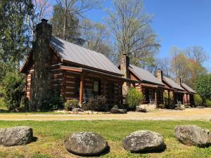 a log cabin with rocks in front of it at Lover's Leap in Sevierville