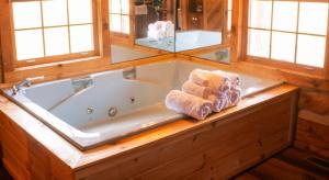 a bathroom with a tub with towels on a counter at Lover's Leap in Sevierville