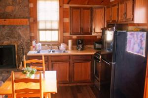 a kitchen with wooden cabinets and a stainless steel refrigerator at Lover's Leap in Sevierville