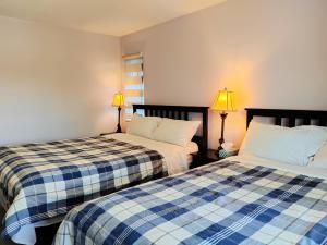 two beds sitting next to each other in a room at Bed Plus House close YVR Airport in Richmond