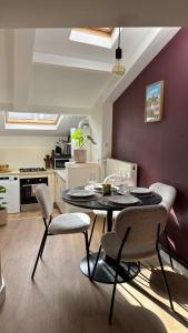 a dining room with a table and chairs in a kitchen at Le 120 Amiens in Amiens
