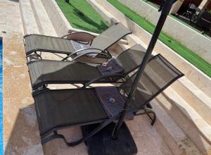 a bench sitting on the side of a street at Villa Barias in Baní +7 photos