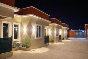 a house with lights on the side of it at KIFA Stays in Laniya +3 photos