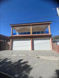 a house with two garage doors in front of it at Villa Barias in Baní