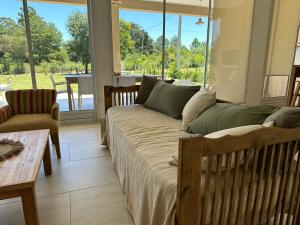 a living room with a couch and a table at Casaquinta overlooking the golf course in Concepción del Uruguay