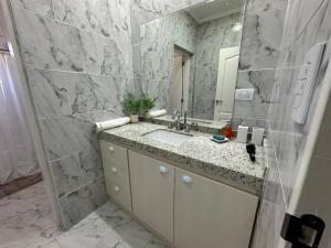 a bathroom with a sink and a mirror at Casaquinta overlooking the golf course in Concepción del Uruguay