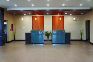 a lobby with blue and orange walls and plants at La Quinta by Wyndham Cotulla in Cotulla +29 photos