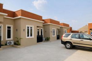 a car parked in front of a house at KIFA Stays in Laniya